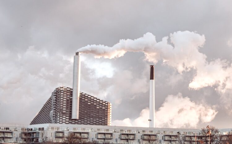 white and gray factory under cloudy sky during daytime